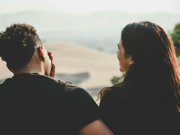 Two people looking out towards the sea.
