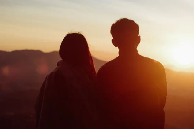 Silhouette of two people at sunset.